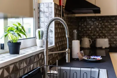 a kitchen sink with a faucet on a counter at GuestReady – Charming Getaway by Madeira's Nature in Santana