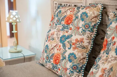 a pillow sitting on a bed next to a lamp at Ohana - Casa de Praia by YOUR KEY in Porto Santo