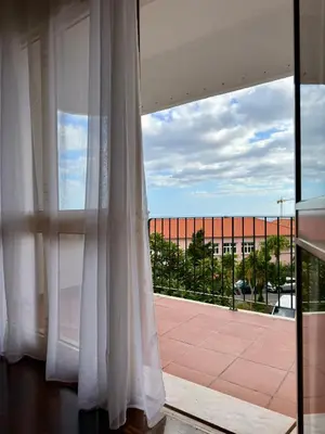 a large window with a view of a building at Ohana Funchal in Funchal