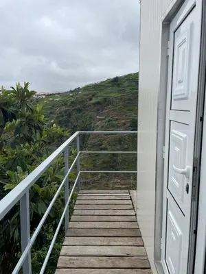 a stairway leading to a door with a view at Charming hill view retreat in Funchal