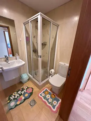 a bathroom with a shower and a toilet and a sink at Heart of Madeira in Funchal