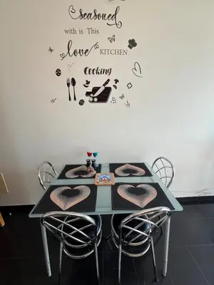 a table with chairs and a table with hearts on the wall at Heart of Madeira in Funchal