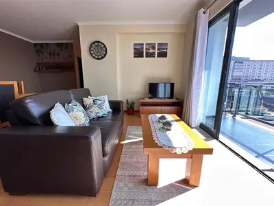 a living room with a leather couch and a coffee table at Heart of Madeira in Funchal