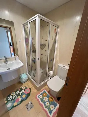 a bathroom with a shower and a toilet and a sink at Heart of Madeira in Funchal