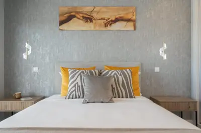 a bedroom with a large white bed with orange pillows at Vila da Ponta do Pargo by An Island Apart in Ponta do Pargo