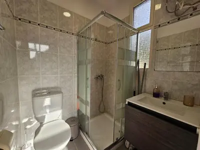 a bathroom with a shower and a toilet and a sink at Villa Rodrigues 1 by Rentallido in Campanário
