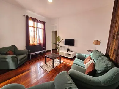 a living room with a couch and a tv at Villa Rodrigues 1 by Rentallido in Campanário