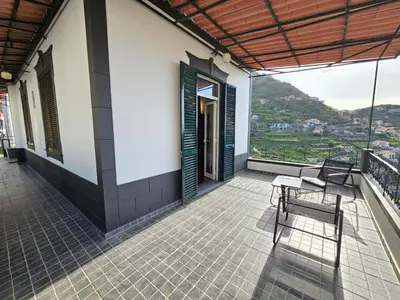 a balcony of a house with chairs and a view at Villa Rodrigues 1 by Rentallido in Campanário