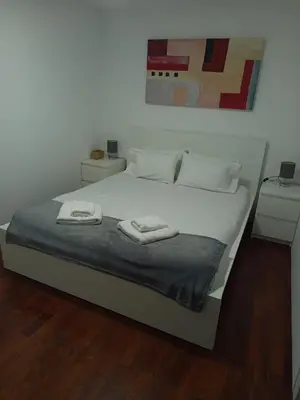 a white bed with two towels on top of it at Villa Rodrigues 2 by Rentallido in Campanário