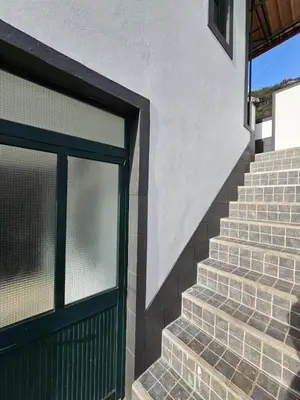 a set of stairs with a green door at Villa Rodrigues 2 by Rentallido in Campanário