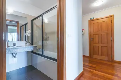 a bathroom with a sink and a mirror at Senhora do Pilar by Atlantic Holiday in Santo António