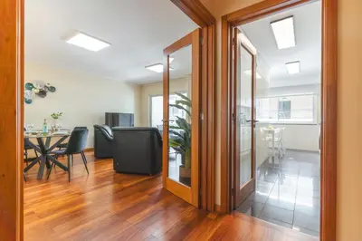 a living room with a dining room table and a sliding glass door at Senhora do Pilar by Atlantic Holiday in Santo António