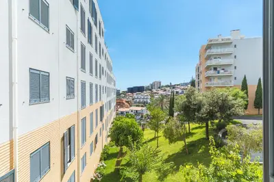 a view from the side of a building with trees and buildings at Senhora do Pilar by Atlantic Holiday in Santo António