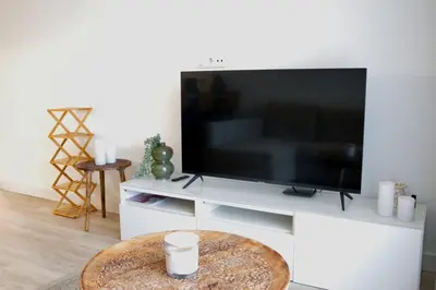 a living room with a large flat screen tv at Apartamento Malino in Sagres