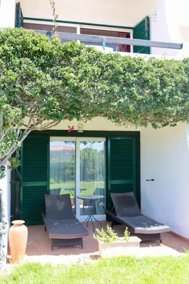 a patio with two chairs and a table at Apartamento Malino in Sagres