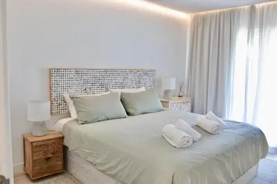 a bedroom with a bed with two pillows on it at Apartamento Malino in Sagres