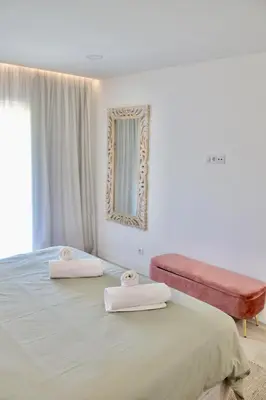 a bedroom with a large bed with two towels on it at Apartamento Malino in Sagres