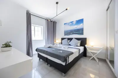 a bedroom with a bed and a desk in it at Casa da Praça - Vila do Bispo, Algarve in Vila do Bispo