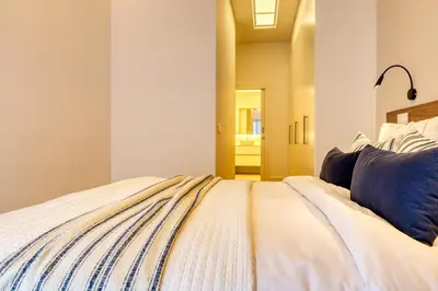 a bedroom with a bed with a blue pillow on it at Funchal Acqua Blue 3O, a Home in Madeira in Funchal