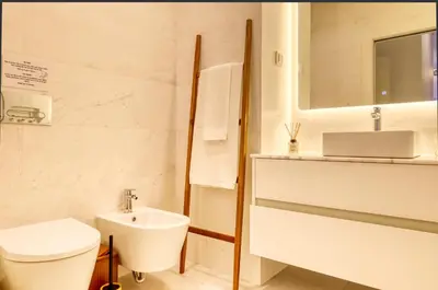a white bathroom with a toilet and a sink at Funchal Acqua Blue 3O, a Home in Madeira in Funchal