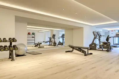 a gym with several treadmills and weights in a room at Funchal Acqua Blue 3O, a Home in Madeira in Funchal