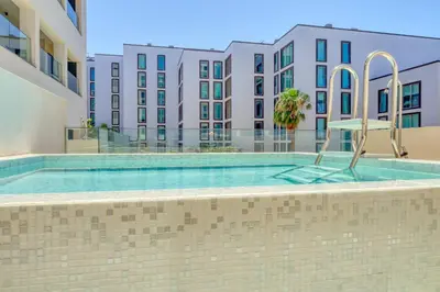 a swimming pool in front of a building at Funchal Acqua Blue 3O, a Home in Madeira in Funchal