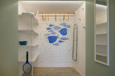 a bathroom with blue and white fish on the wall at Casa Velha da Lagoa - Peixe by Mth in Ponta do Sol