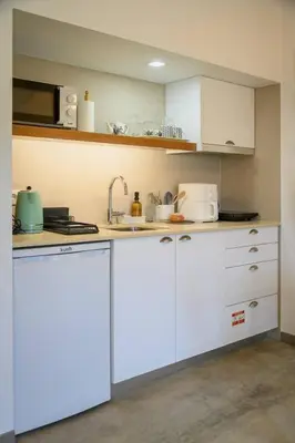 a kitchen with white cabinets and a sink at Casa Velha da Lagoa - Peixe by Mth in Ponta do Sol
