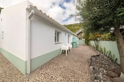 a side view of a white house with a pathway at Casa Velha da Lagoa - Peixe by Mth in Ponta do Sol