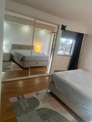 a bedroom with a bed and a large mirror at Relax accommodation in Funchal