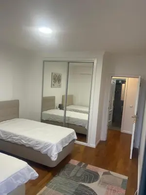 a bedroom with two beds and a mirror at Relax accommodation in Funchal