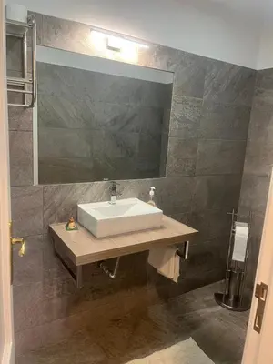 a bathroom with a sink and a mirror at Relax accommodation in Funchal