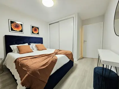 a bedroom with a large bed with orange pillows at Garajau Palace Sea View II by Rentallido in Caniço
