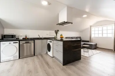 a kitchen with a washer and dryer in a room at Barreiro View in Ribeira Brava