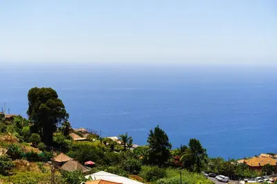 a view of the ocean from a hill with houses at Barreiro View in Ribeira Brava