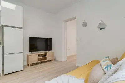 a living room with a couch and a flat screen tv at Casa Teixeira by Holiday Rental Madeira in Senhora do Rosário