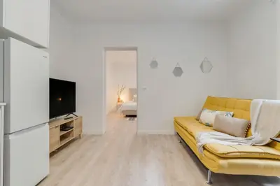 a living room with a yellow couch and a television at Casa Teixeira by Holiday Rental Madeira in Senhora do Rosário