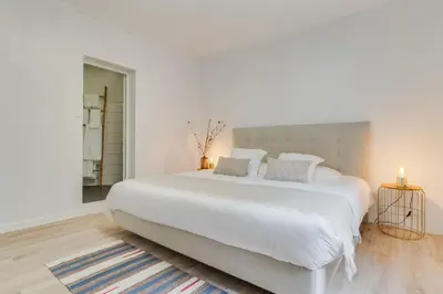 a white bedroom with a large white bed at Casa Teixeira by Holiday Rental Madeira in Senhora do Rosário