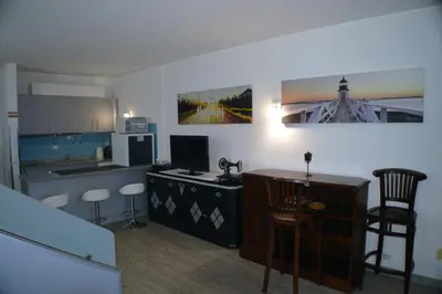 a kitchen with a desk and a counter with a computer at Apartamento Gois in Machico