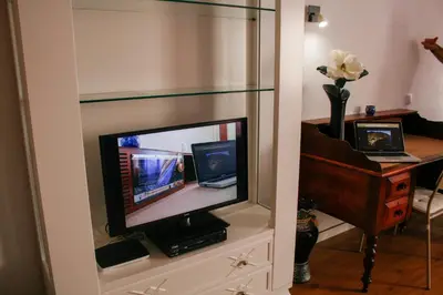 a television sitting on a dresser in a room at Apartamento Gois in Machico