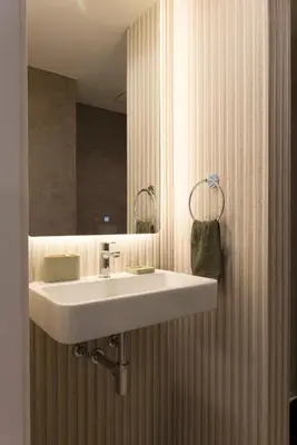 a bathroom with a sink and a shower with a mirror at Madeira Acqua Suite in Funchal