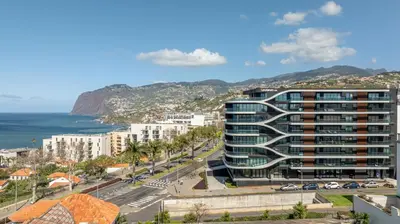 a view of a city with the ocean and buildings at Oceanview Penthouse in Funchal in Funchal