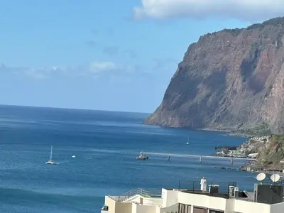 a view of a body of water with a mountain at Oceanview Penthouse in Funchal in Funchal
