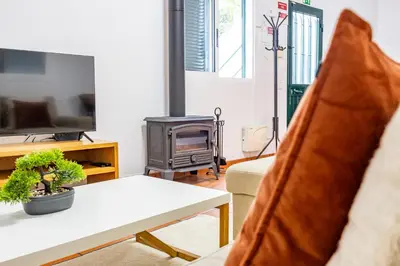 a living room with a couch and a stove at Pena Vista Mar Funchal by YOUR KEY in Funchal