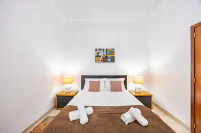 a bedroom with a large bed with two night stands at Pena Vista Mar Funchal by YOUR KEY in Funchal