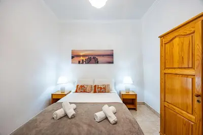 a bedroom with a bed with two pillows at Pena Vista Mar Funchal by YOUR KEY in Funchal