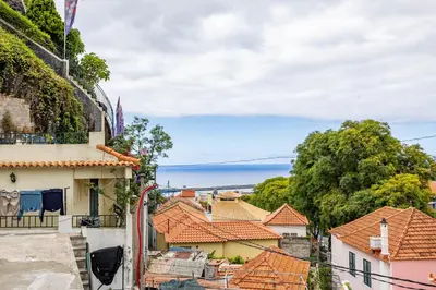 a view of roofs of houses and the ocean at Pena Vista Mar Funchal by YOUR KEY in Funchal