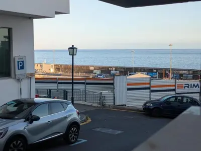 a living room with a table and a couch at Princess Flower in Funchal