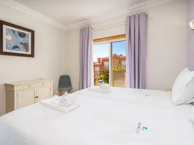 a bedroom with two white beds and a window at Relax and golf at Boavista Golf Spa Resort #1968 in Lagos