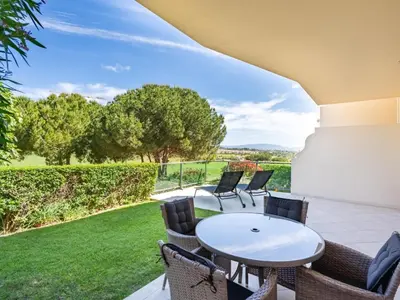a patio with a white table and chairs and a lawn at Relax and golf at Boavista Golf Spa Resort #1968 in Lagos